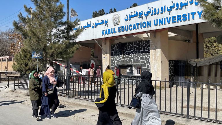Female students walk in front of the Kabul Education University in Kabul, Afghanistan