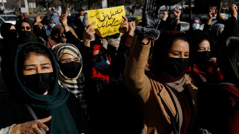 Afghan women chant slogans in protest against the closure of universities to women by the Taliban in Kabul