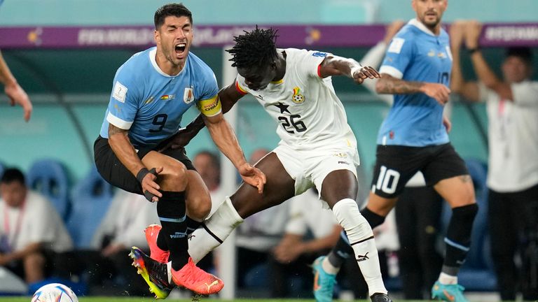 Ghana&#39;s Alidu Seidu, right, challenges Uruguay&#39;s Luis Suarez