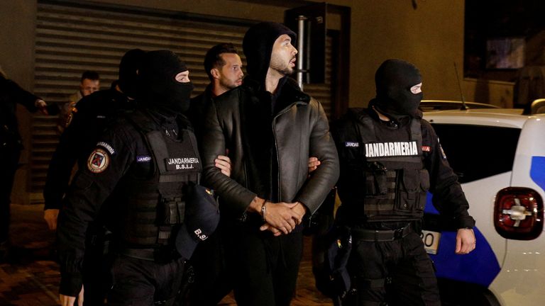 אנדרו טייט וטריסטן טייט מלווים על ידי שוטרים מחוץ למטה המנהל על חקירת פשע וטרור מאורגן בבוקרשט (דיקו) לאחר שנעצר במשך 24 שעות, בבוקרשט, רומניה