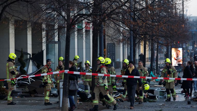 Emergency crews work on a street outside a hotel after the AquaDom aquarium in central Berlin near Alexanderplatz leaked, spilling water onto the street, in Berlin, Germany, December 16, 2022. REUTERS/ Michele Tantussi