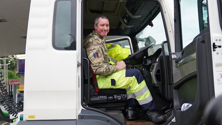 A member of the armed forces sits in the cab of a tanker after helping to deliver fuel to a garage in Waltham Abbey, Essex