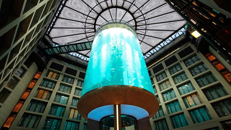 The lobby of the DomAquarée hotel with a massive aquarium in the center.  Berlin, Germany