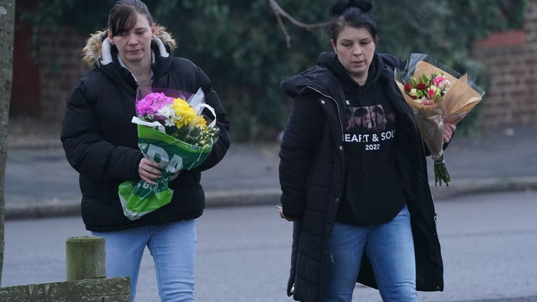 Two women left flowers at the scene on Monday