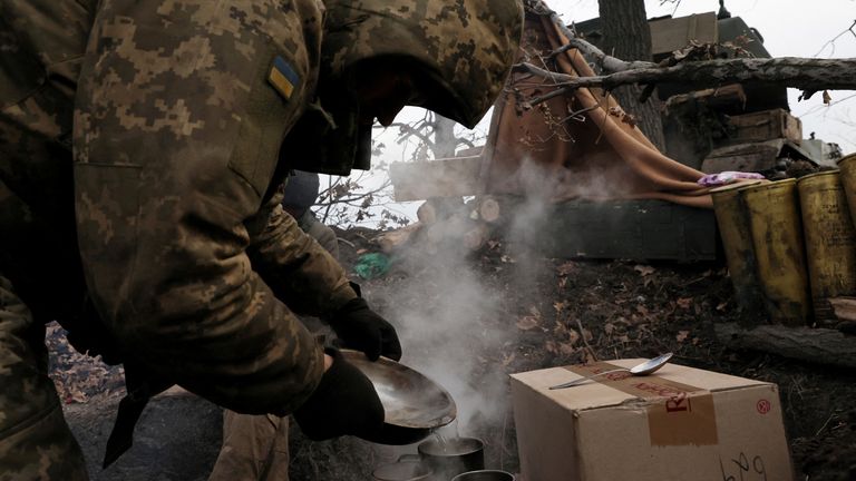 Self propelled artillery vehicle operator Sergiy prepares coffee