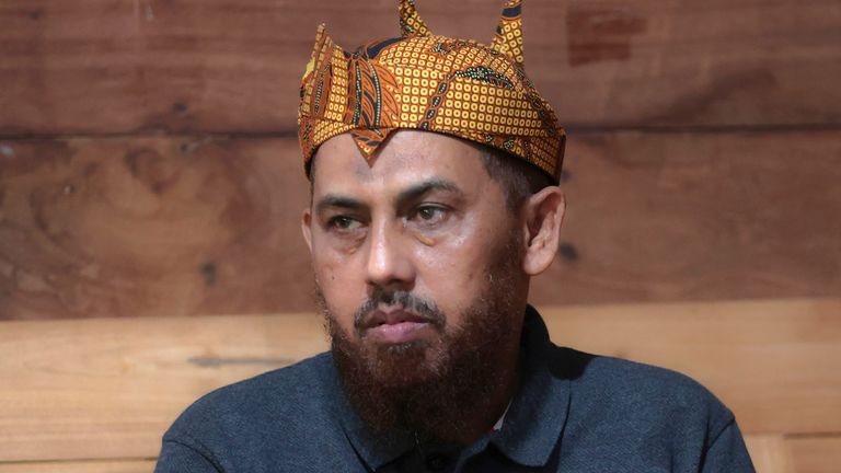 Indonesian militant Umar Patek pauses during his visit at the house of his long-time friend Ali Fauzi, a former militant who now runs a de-radicalization program, in Lamongan, East Java, Indonesia, Tuesday, Dec. 13, 2022. Patek, who was convicted of making the explosives used in the 2002 Bali bombings, apologized to victims&#39; families after his release from prison despite objection from Australia. (AP Photo/Trisnadi)