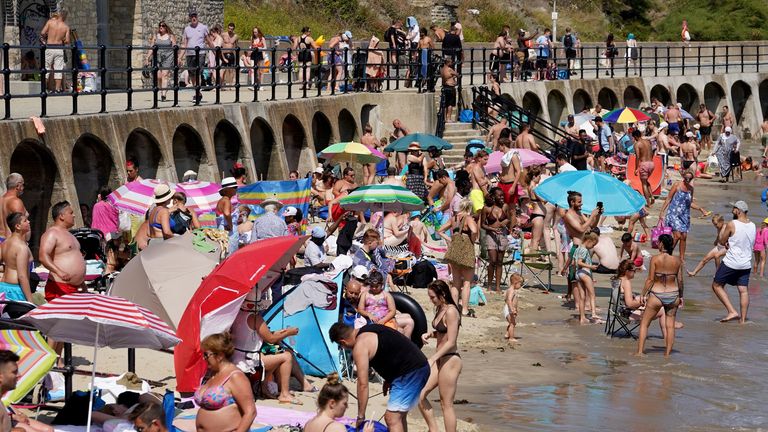People enjoy the beach in Folkestone, Kent, during the hot weather.Picture date: Monday July 18, 2022.