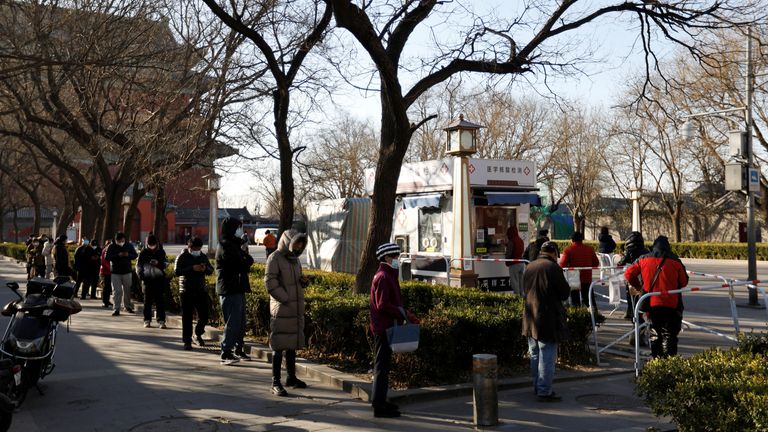 People line up at a nucleic acid testing site to get tested for COVID-19 in Beijing