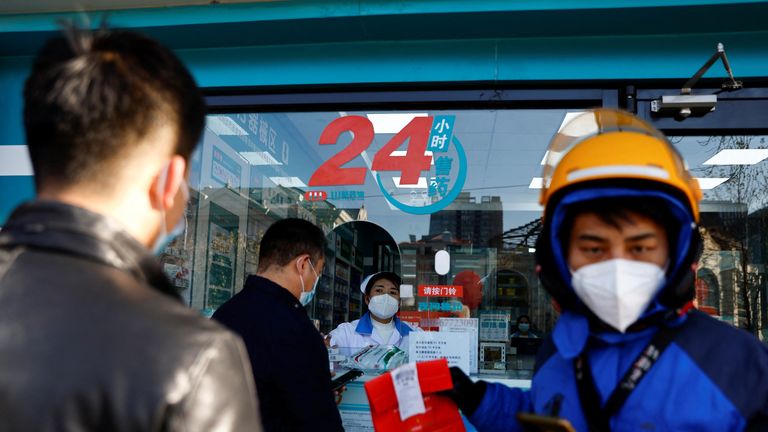 People line up to buy fever and cold medicine in Beijing