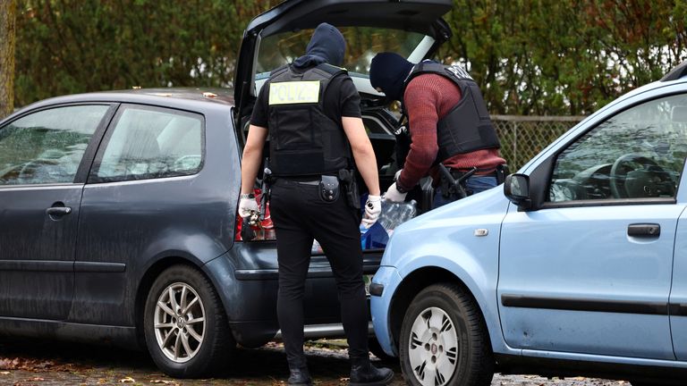 Police search a car as they secure the area after 25 suspected members and supporters of a far-right group were detained during raids across Germany, in Berlin, Germany December 7, 2022. REUTERS/Christian Mang
