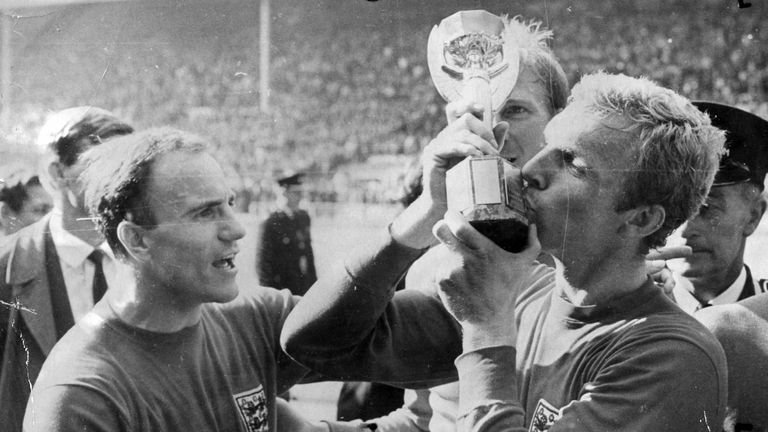 England&#39;s George Cohen (l) Looks On As Captain Bobby Moore (r) Kisses The Jules Rimet Trophy After England Won The 1966 World Cup Final Beating Germany 4-2 At Wembley Stadium.

