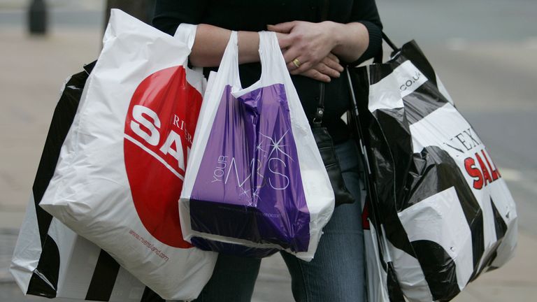 A shopper carries bags in Oxford Street, London. Pic: Reuters 