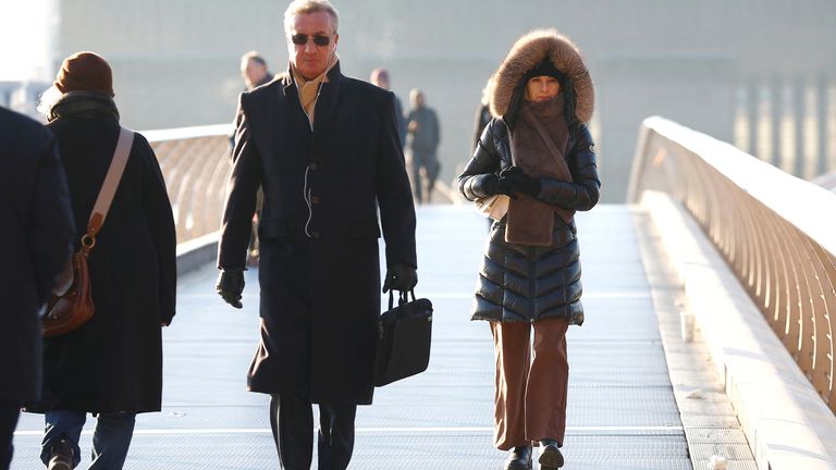 People walk across Millennium Bridge as temperatures in London fall below zero degrees Celsius, in London, Britain, December 8, 2022. REUTERS/Peter Nicholls