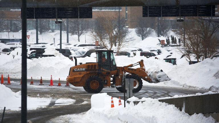 A worker uses heavy machinery to remove snow at Buffalo Niagara International Airport, following a deadly Christmas blizzard, in Cheektowaga, New York, U.S., December 27, 2022. REUTERS/Robert Kirkham