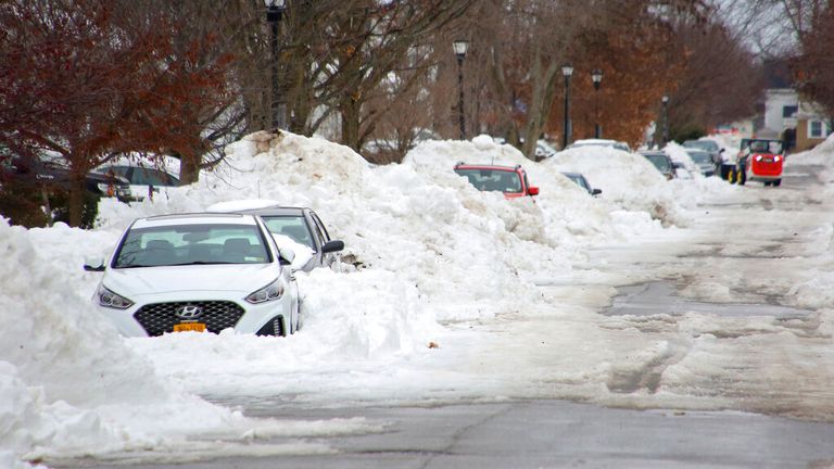 Snow covered cars line a side street a few days after a winter storm rolled through Western New York Thursday, Dec. 29, 2022, in Buffalo, N.Y. (AP Photo/Jeffrey T. Barnes)