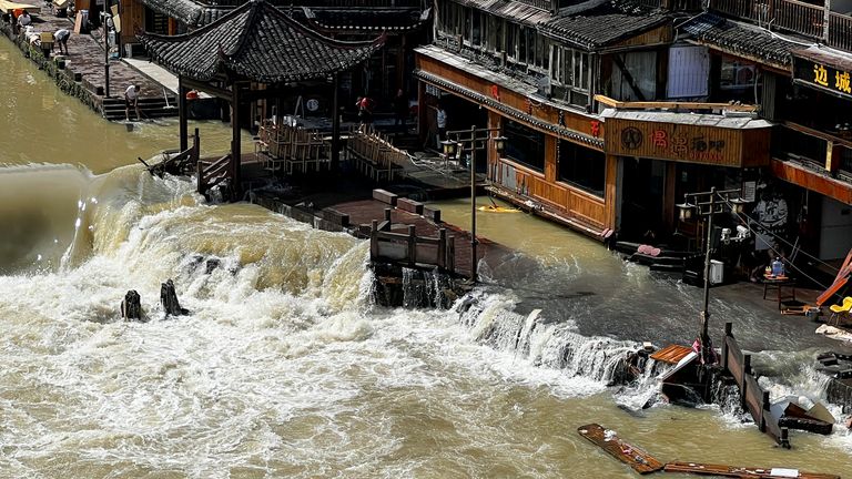 Flood waters sweep through the ancient town of Feng Huang in central China&#39;s Hunan province, Saturday, June 4, 2022. State media reported some deaths and missing in flooding in the province. (AP Photo)