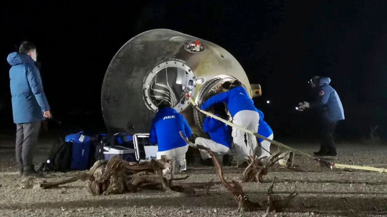 Ground crew checks on the astronauts inside the re-entry capsule of the Shenzhou-14 manned space mission