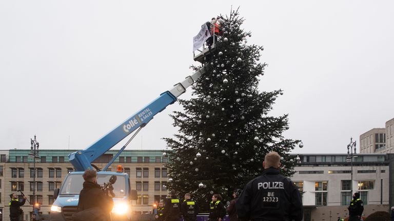 activists from the environmental group drove a forklift past the Christmas tree on Pariser Platz at the Brandenburg Gate.  Photo: AP