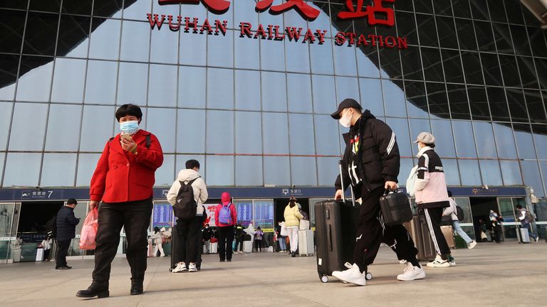 People enter a railway station, after the government eased curbs on the coronavirus disease (COVID-19) control, in Wuhan, Hubei province, China December 11, 2022. REUTERS/Martin Pollard