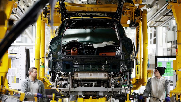 Staff members work on a Bentayga SUV on the Bentley production line at their factory in Crewe, Britain, December 7, 2022. REUTERS/Phil Noble     TPX IMAGES OF THE DAY     