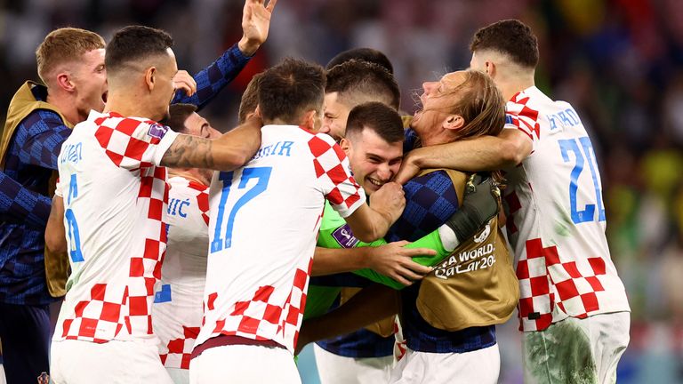 Croatia&#39;s Dominik Livakovic celebrates with teammates after winning the penalty shootout