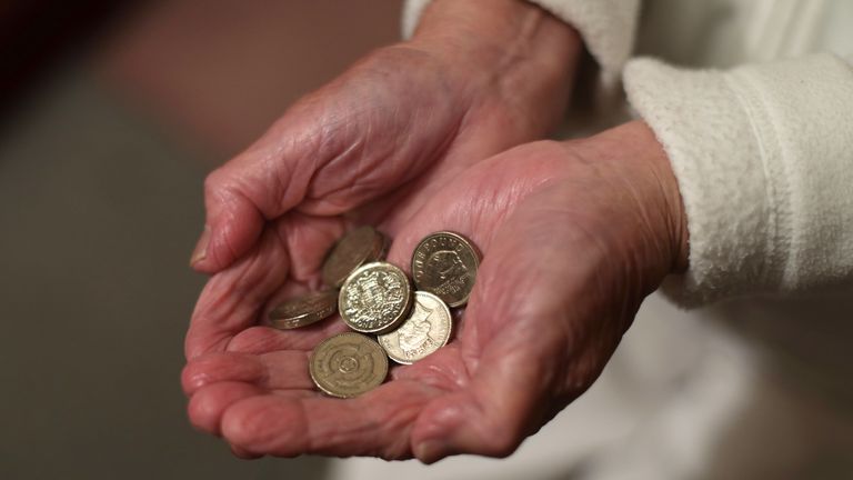 File photo dated 22/12/16 of an elderly woman holding pound coins in her hands, in Poole, Dorset. 