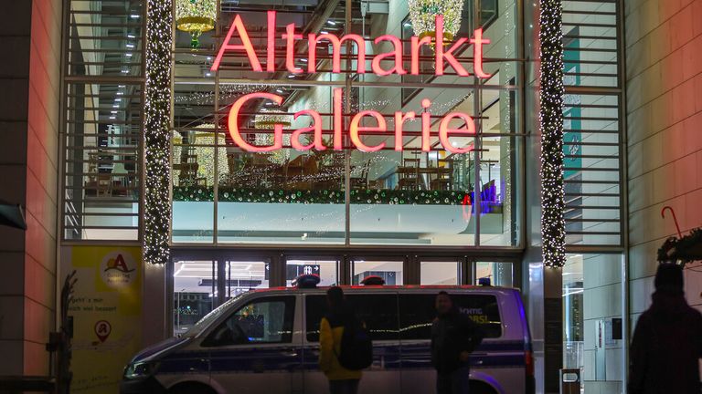 A police car is parked in front of the closed Altmarkt Galerie in Dresden Pic: AP 
