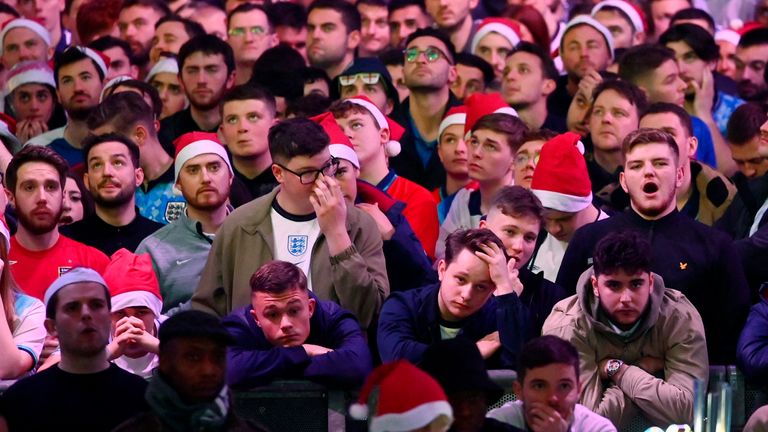 Sad-looking England fans are pictured in London 