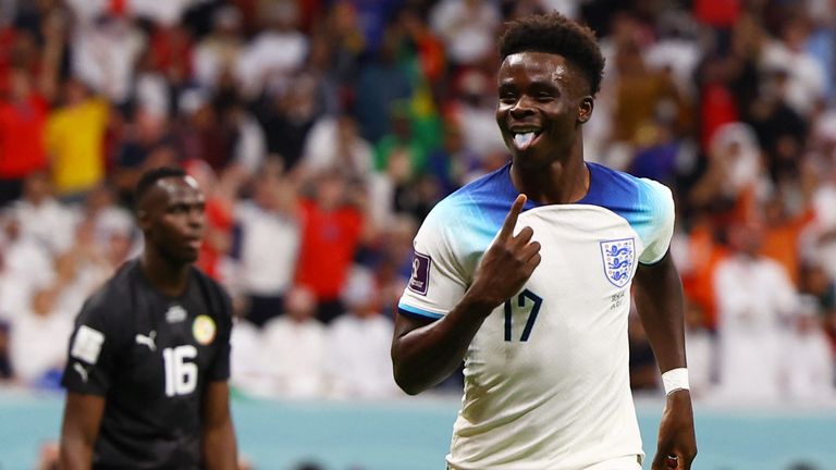 Soccer Football - FIFA World Cup Qatar 2022 - Round of 16 - England v Senegal - Al Bayt Stadium, Al Khor, Qatar - December 4, 2022 England&#39;s Bukayo Saka celebrates scoring their third goal REUTERS/Kai Pfaffenbach