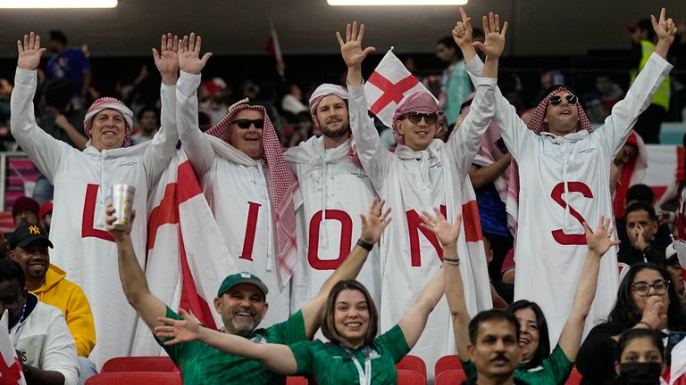 Fans cheer as they wait for the start of a World Cup quarterfinal soccer match between England and France, at the Al Bayt Stadium in Al Khor, Qatar, Saturday, Dec. 10, 2022. (AP Photo/Abbie Parr)
