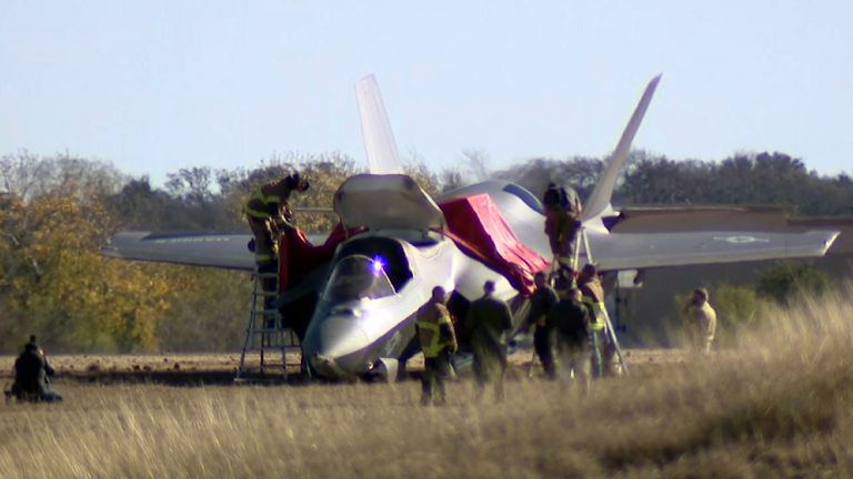 This image, taken from video provided by KDFW, shows first responders at the scene after a fighter jet crashed at the Naval Air Station Joint Reserve Base in Fort Worth, Texas, on Thursday, Dec. 12.  On 15th 2022, the pilot ejected safely after a failed landing.  (KDFW via AP)