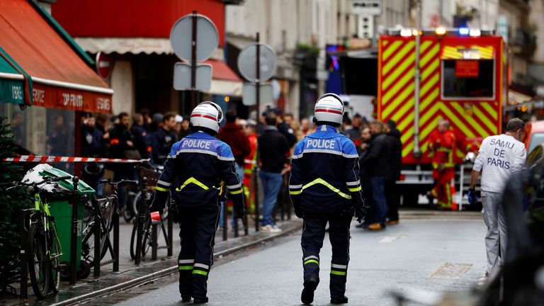 French police an firefighters secure a street after gunshots were fired killing two people and injuring several in a central district of Paris, France, December 23, 2022. REUTERS/Sarah Meyssonnier
