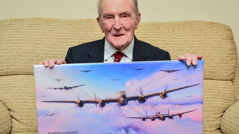 File photo dated 05/01/17 of George "Johnny" Johnson, then aged 95, holds a picture of Lancaster bombers at his home in Bristol. Mr Johnson, the last surviving Dambuster, has died at the age of 101. He was part of Royal Air Force 617 Squadron, which conducted a night of raids on German dams in 1943 in an effort to disable Hitler&#39;s industrial heartland. Issue date: Thursday December 8, 2022.
