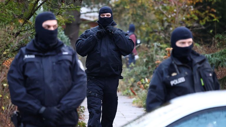 Police secures the area after 25 suspected members and supporters of a far-right group were detained during raids across Germany