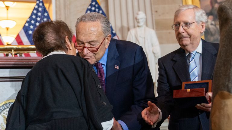 Gladys Sicknick, left, mother of slain US Capitol Police officer Brian Sicknick, is greeted by Senate Majority Leader Chuck Schumer.  photo: AP 