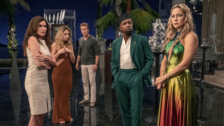 Glass Onion: A Knives Out Mystery (2022). (L-R) Kathryn Hahn as Claire, Madelyn Cline as Whiskey, Edward Norton as Miles, Leslie Odom Jr. as Lionel, and Kate Hudson as Birdie. Cr. John Wilson/Netflix .. 2022.