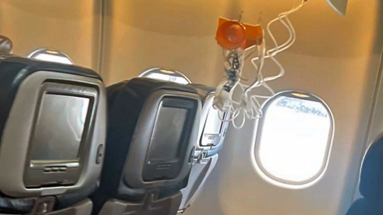 This mobile photo courtesy of passenger Jazmin Bitanga shows the interior of a Hawaiian Airlines plane on its flight from Phoenix to Honolulu, Sunday, Dec. 18, 2022, after severe turbulence rocked the flight. (Courtesy of Jazmin Bitanga via AP)