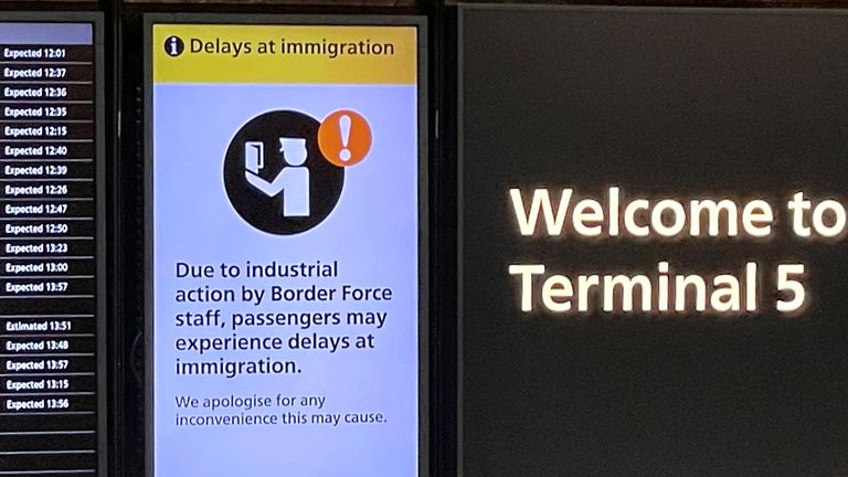 An arrivals board displays a message warning users of terminal 5 about industrial action by Border Force staff, at Heathrow Airport, near London, Britain, December 23, 2022. REUTERS/Peter Nicholls
