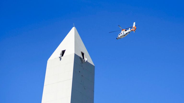 A helicopter carrying national team players flies over the Obelisk monument in Buenos Aires