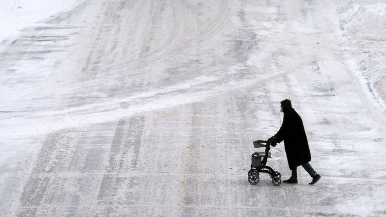 A pedestrian walks through a snow-covered downtown street on Thursday, Dec. 12.  22, 2022 Des Moines, Iowa PIC:AP