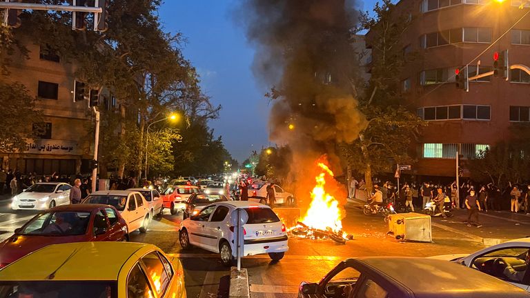 A police motorcycle burns during a protest over the death of Mahsa Amini, a woman who died after being arrested by the Islamic republic&#39;s "morality police", in Tehran, Iran September 19, 2022. WANA (West Asia News Agency) via REUTERS ATTENTION EDITORS - THIS IMAGE HAS BEEN SUPPLIED BY A THIRD PARTY. ATTENTION EDITORS - THIS PICTURE WAS PROVIDED BY A THIRD PARTY