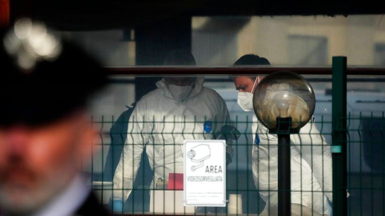 Forensic police officers inspect a bar where three people died after a man entered and shot in Rome, Sunday, Dec. 11, 2022. (AP Photo/Gregorio Borgia)