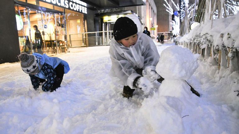 Children play in the snow in Kanazawa. Pic: AP