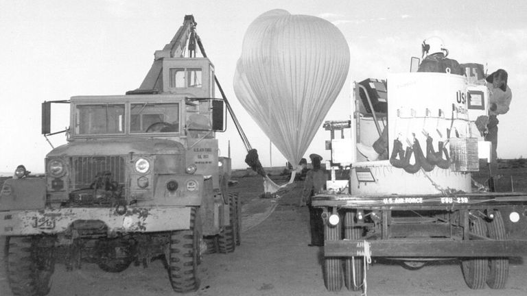 Captain Joseph Kittinger Jr. waits in the open balloon gondola, right, as two million cubic foot polyethylene balloons are filled with helium for the Excelsior I test jump at White Sands Missile Range, NM, November 16, 1959