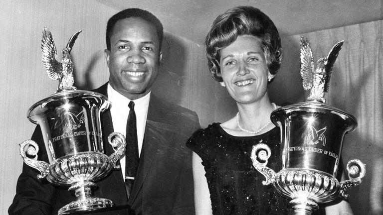 Baseball star Frank Robinson of the Baltimore Orioles, left, and golfer Kathy Whitworth of San Antonio, Texas, arrive for the Sportsman and Woman of the Year Trophy on February 12 in San Antonio, California.  On November 11, 1967, the Associated Press nominated two men to receive awards from the Brotherhood of Eagles. (AP Photo/Robert Huston) Image: AP