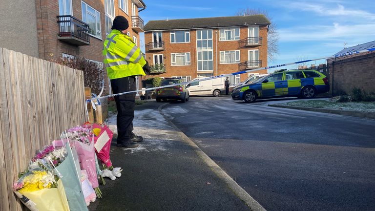 Flowers have been left next to a police cordon