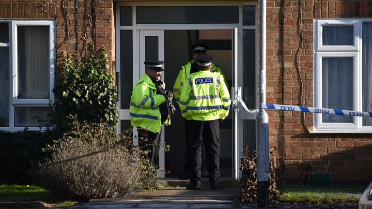 Police officers at the scene in Kettering, Northamptonshire. Northamptonshire Police have named a woman and two children who died in a suspected murder in Kettering as 35-year-old Anju Asok, six-year-old Jeeva Saju and Janvi Saju, four.
