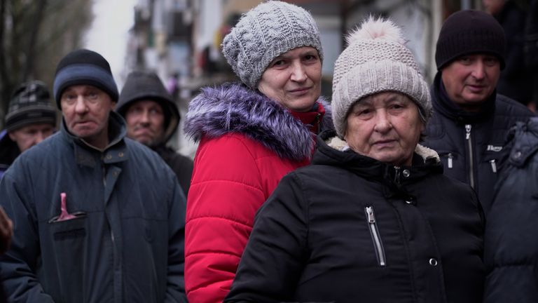 Kherson residents waiting to receive food and aid in the cold 