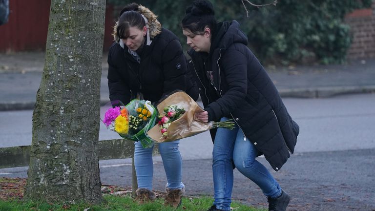 Members of the public lay flowers near to the scene in Babbs Mill Park in Kingshurst, Solihull. Four children are in critical condition in hospital after being pulled from an icy lake