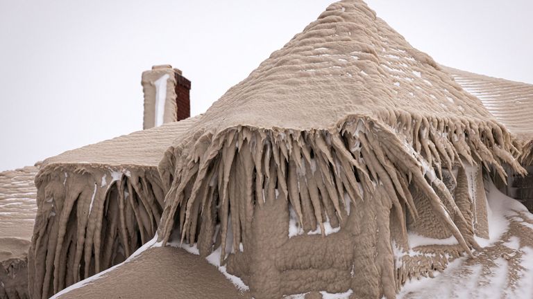 Ice formed by the spray of Lake Erie waves covers a restaurant during a winter storm in Hamburg, New York, U.S., December 26, 2022.  REUTERS/Lindsey DeDario